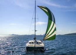 Catamaran Mahayana under spinaker